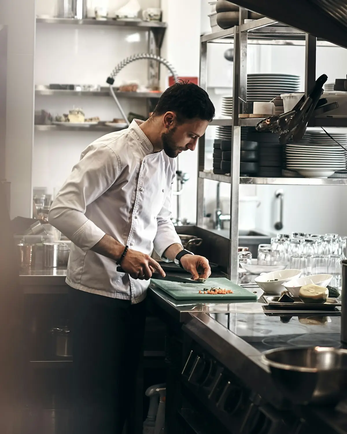 A chef chopping fresh vegetables in the kitchen