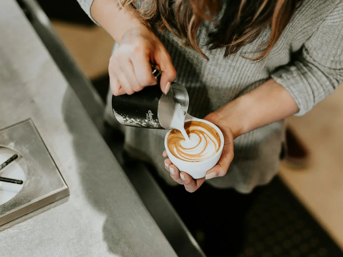 Coffee being poured into a white cup